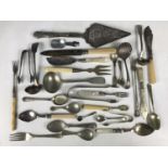 A quantity of electroplate cutlery including ladles, caddy spoons and sugar tongs etc
