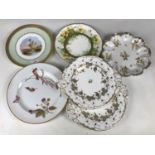 Seven 19th Century porcelain plates, including two Rockingham type cake plates, a hand-enamelled and