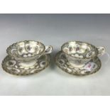 A pair of 19th Century Rockingham style porcelain tea cups and saucers, transfer-printed, hand-