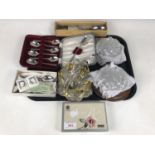 Sundry cut glass butter dishes together with a sugar basin and cased sets of electroplate cutlery