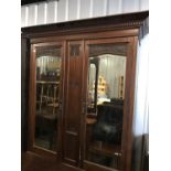 A late Victorian carved mahogany two door wardrobe