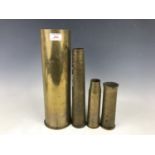 Four brass artillery shell cases