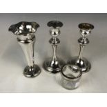 A pair of silver candlesticks (one a/f) together with a silver vase and a silver rimmed pot