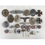 A quantity of reproduction German Third Reich insignia etc