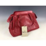 An Aquascutum of London red leather "Blunsom" handbag, having a chequered cotton lining, and