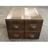 An oak four-drawer filing cabinet with brass handles, second quarter 20th Century, 39 x 40 x 30 cm