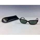 A vintage pair of Ray-Ban sunglasses, in original black leather case