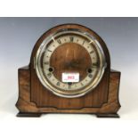 An Enfield oak and walnut mantel clock