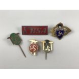 A group of lapel badges and a brooch including 1954-5-6 Isle of Man TT races pin badges and an