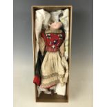 A late 19th / early 20th century porcelain doll wearing traditional Swiss costume (doll a/f)