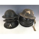A number of Second World War Civil Defence helmets