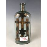 A 19th century miner's / folk art cross in glass bottle