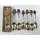 Six enamelled silver commemorative spoons and an anointing spoon