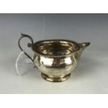 A silver cream jug