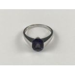 A contemporary 9ct white gold and amethyst dress ring, the oval-cut amethyst of approximately 2.4ct