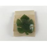 A vintage spinach jade brooch carved in the form of a leaf, 4 cm