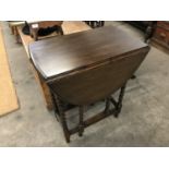 A small 1920s oak drop-leaf occasional table