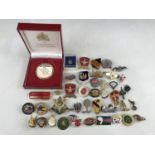 A quantity of military-themed lapel and other badges etc