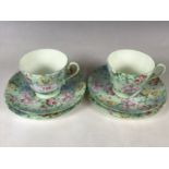 A pair of Shelley porcelain Melody pattern chintz trios, pattern No. 13453