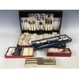 A cased canteen of electroplate cutlery together with a carving set, two boxed knife sets and