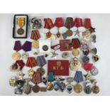 A large quantity of Soviet and other military insignia, medals etc