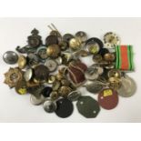 A quantity of military badges and buttons etc