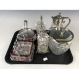 An electroplate-mounted glass claret jug together with a biscuit barrel, pickle jars and preserve