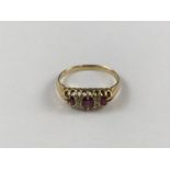 A vintage high-carat gold, ruby and diamond dress ring, having three graded rubies interspersed by