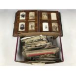 A Victorian cartes-de-visite album, containing CDV's, postcards and photographs