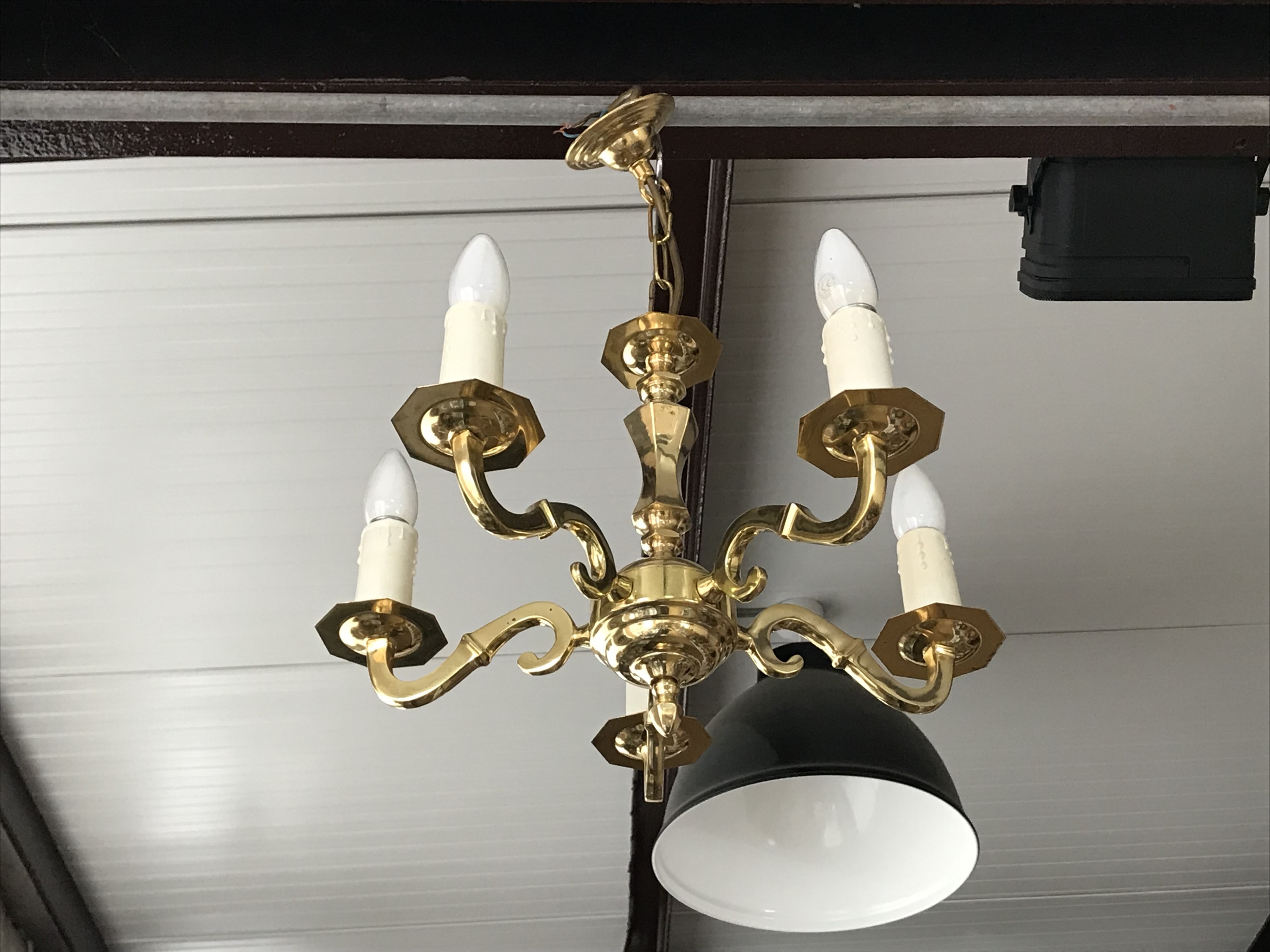 A contemporary reproduction brass five-branch chandelier