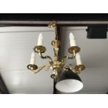 A contemporary reproduction brass five-branch chandelier