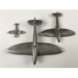 A die-cast toy and "trench art" model Spitfire aircraft