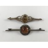A silver and citrine brooch of Celtic influence, together with one other similar set with marcasite,