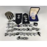 Police insignia including epaulettes, rank badges and buttons, a Tower Mint Metropolitan Police