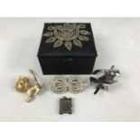 A beaded ring box containing a small quantity of vintage costume brooches, together with a white