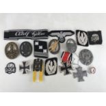 A quantity of reproduction German Third Reich insignia etc