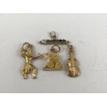 9ct gold and yellow metal pendants / charms, to include an acrostic pendant spelling out the word '