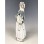 A Lladro figurine of a girl with lamb, circa 1960s