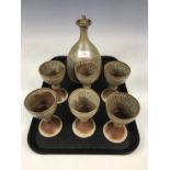 A studio pottery decanter and six goblets
