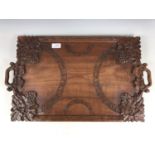 An oriental carved wooden tray