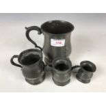 A Victorian pewter baluster tankard and conforming measures