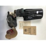 Second World War gas masks together with a related ARP handbook