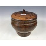 An antique rustic Chinese wooden lidded box of coopered construction with lion-form lid finial