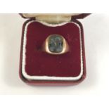 A 9ct gold and onyx signet ring, the hardstone matrix intaglio engraved with the head of a Roman