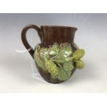 A 19th century Rye pottery milk jug decorated in high relief with hops, 9.5 cm