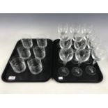 A set of twelve etched wine glasses together with a similar set of six etched glass tumblers