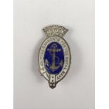 A Second World War 'Knitted Garments for the Royal Navy' enamelled lapel badge