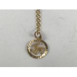 A yellow-metal Isle of Man pendant on a 9ct gold neck chain, 2.7g