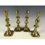 Two pairs of brass candlesticks, 22 & 23 cm