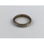 A vintage yellow-metal and paste eternity ring, 2.6g